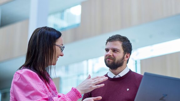 two people in hard hats looking at machinery