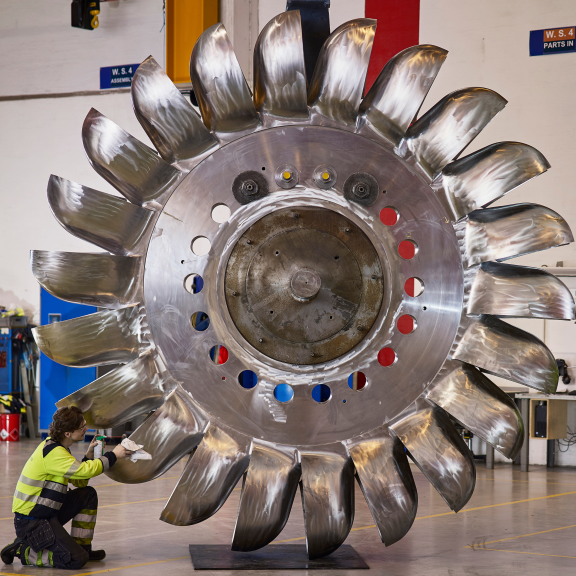 Woman polishes a hydropower turbine